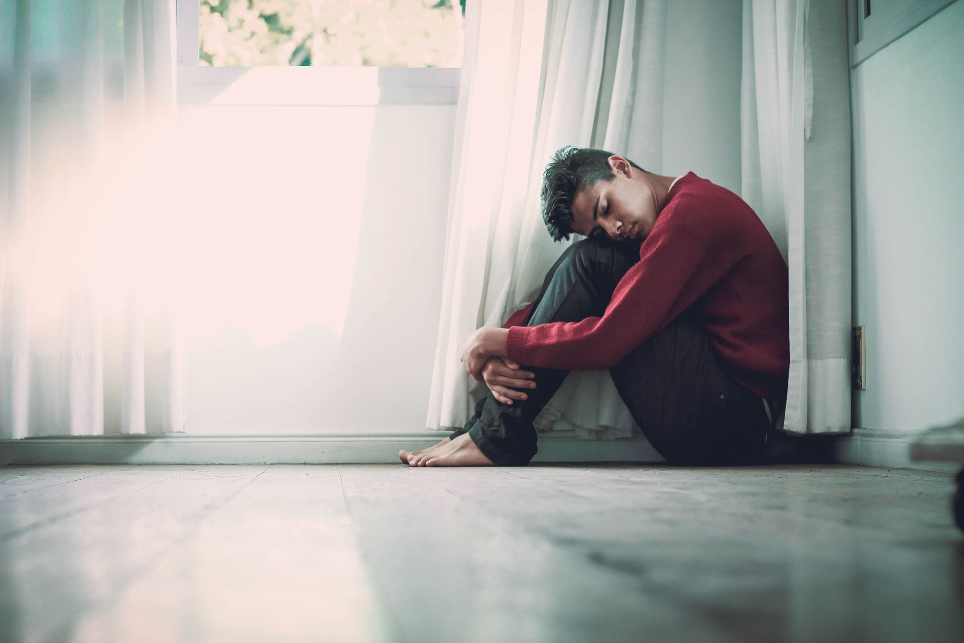 a man sitting in front of a window